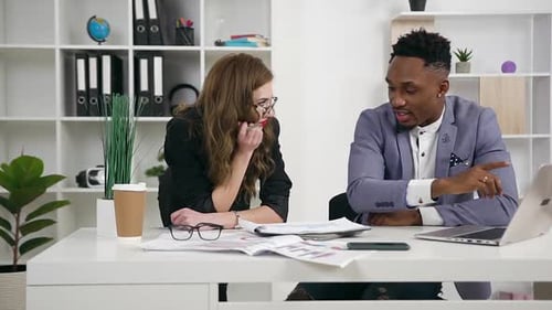 Male and Female Multiracial People Working Together Under Joint Project in Contemporary Office