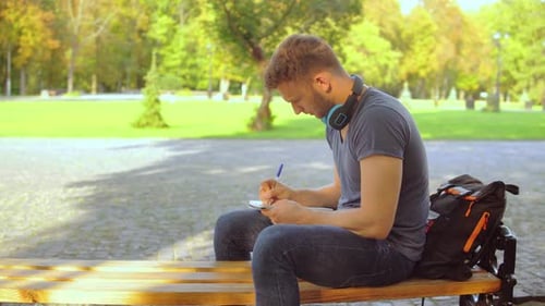 Caucasian Guy Studying at the Open Air
