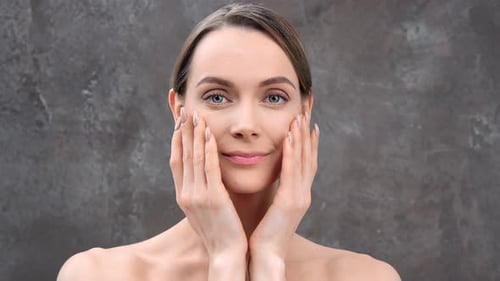 Woman Gently Massaging Her Face in Close-up Shot