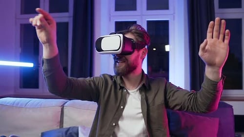 Young Man Experiencing Virtual Reality Headset at Home