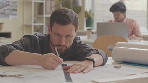 Talented Architect Drawing House Plan in Office