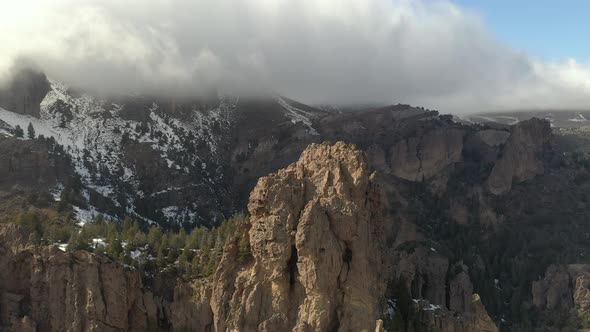 Aerial flying towards high altitude rock formations on the mountains ...