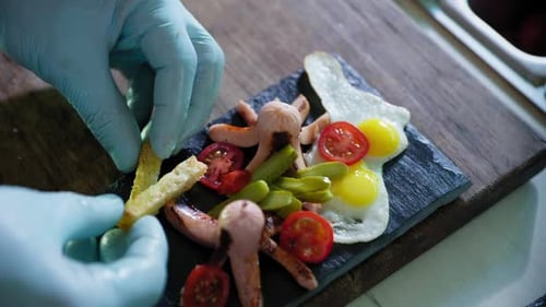 Chef Preparing Fried Eggs and Sausage Meal