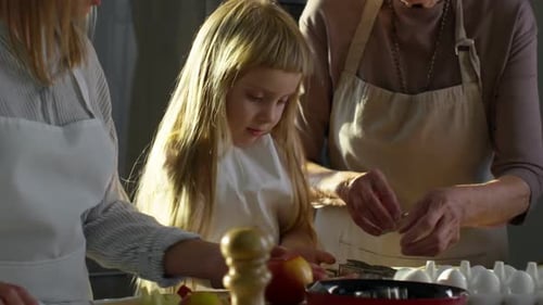Three Generations Making Cookies Together in Kitchen