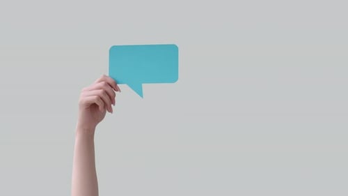 Hand Holding Up Blue Speech Bubble