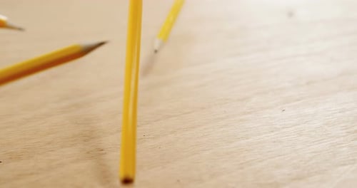 Yellow Pencils Falling in Slow Motion