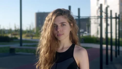 Woman Smiling in Athletic Wear Outdoors