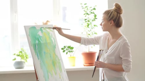 Woman Painting an Abstract on Canvas at Home