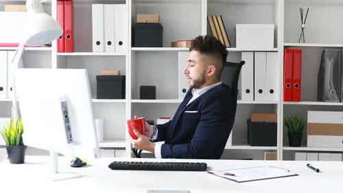 Young Adult Man Working at Office Desk