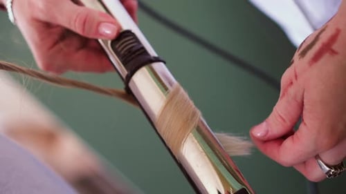 Hairdresser Uses Curling Iron to Make Stylish Lock to Client