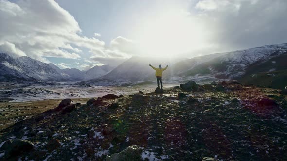 Cover for A Man Stands on Top of a Cliff and Enjoys a Beautiful View