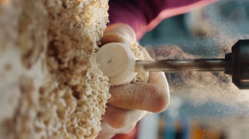 Woodworker Shaping Wooden Peg with Drill, Close Up