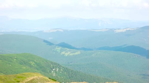 Scenic View of Rolling Mountains in Summer