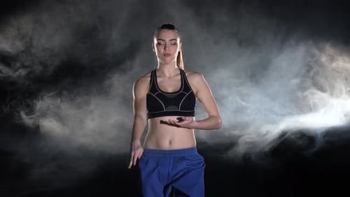 Young Woman Martial Arts Routine on Dark Stage