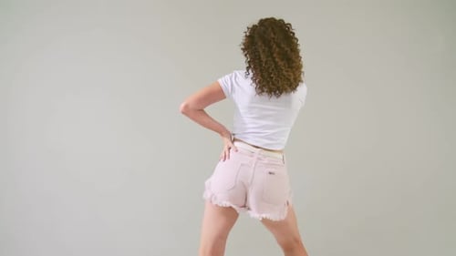 Young Woman Dancing in Pink Shorts