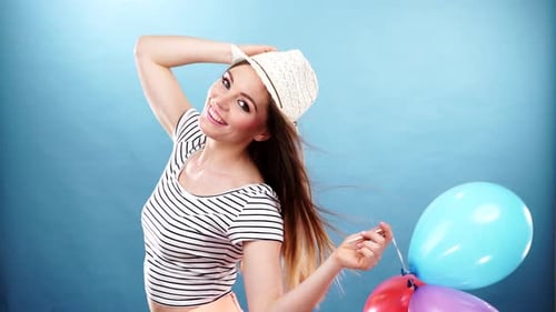 Cheerful Woman Holding Balloons Smiling in Studio