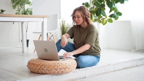 Woman Using Laptop for Video Call at Home