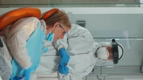 Dentist Performing Dental Procedure on Patient in Hospital