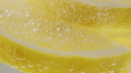 Lemon Slice with Bubbles in Clear Water