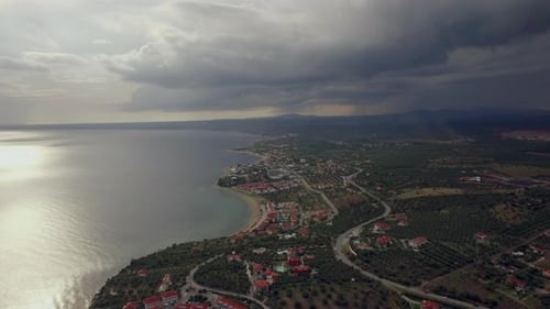 Flying Over Trikorfo Beach Coast and Sea on Overcast Day, Greece