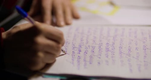 Senior Businessman Writing on Paper at Table in Office