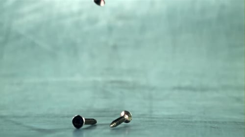 Screws Falling in Slow Motion Studio Shot