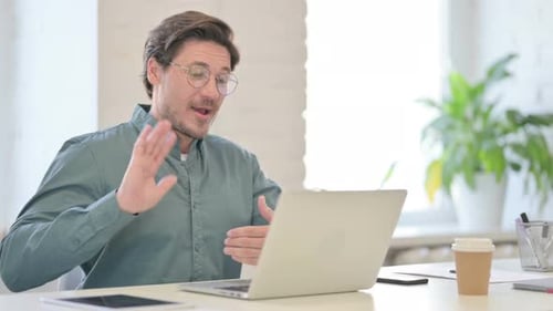 Man Having a Video Call at His Desk