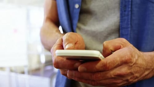 Man Types on Smartphone Inside