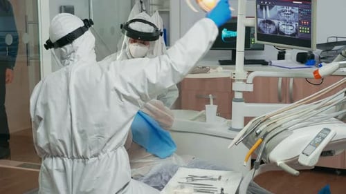 Dentists Performing Oral Surgery in a Clinic