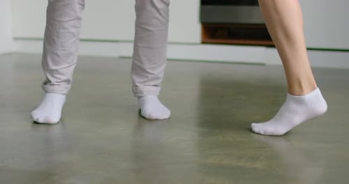 Close Up Feet Young Couple Is Dancing at Home, Wearing White Socks