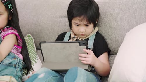 Multi-ethnic young boys and girls happy using technology for study and play games.