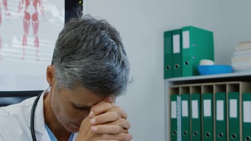 Healthcare Provider Deep in Thought in Office