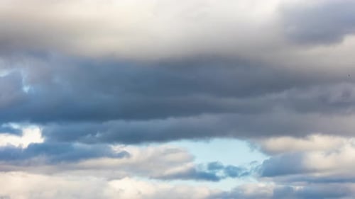 Moving Gray and White Clouds in a Blue Sky