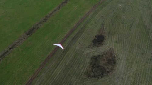 A Hang Glider Flying Over the Field