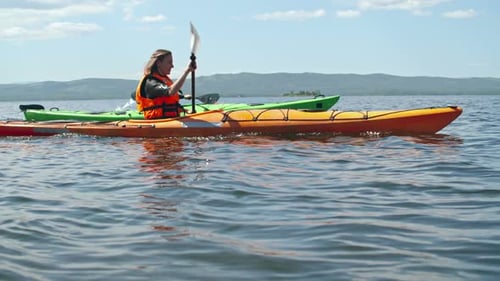 Couple Kayaking on a Sunny Lake Adventure