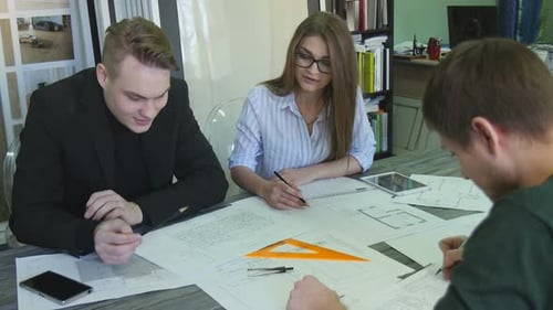 Architects Collaborating on Building Design Plans