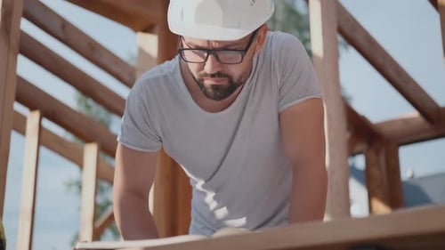 Designer or Foreman at a Construction Site. Build a House with Draws