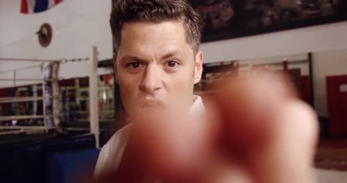 Man Practices Martial Arts Punching In Gym