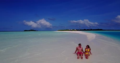 Beautiful lady and man on honeymoon vacation spend quality time on beach on summer white sandy