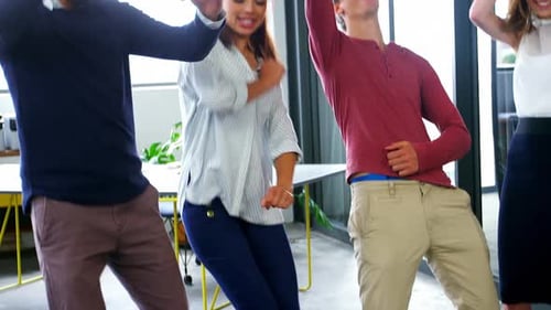Business executives dancing in office