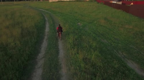 Aerial Steadicam View of Boy Riding a Bike at Summer, Russia