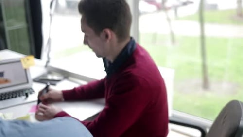 Team Brainstorming with Sticky Notes in Bright Office