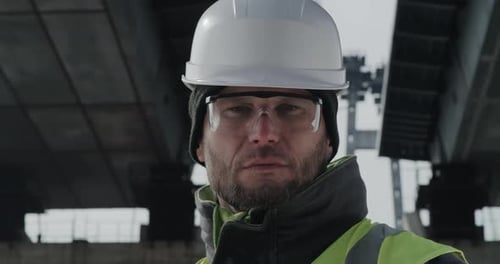 Serious Bridge Builder Looking at Camera