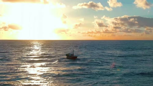 Boat At Sea At Sunset