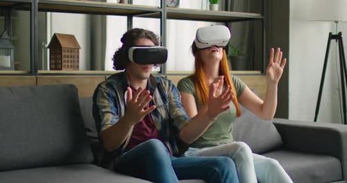 Couple Enjoys Virtual Reality Experience in Living Room