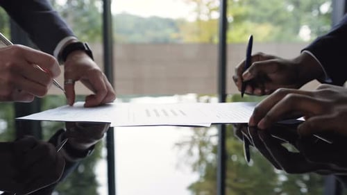 Businessmen Sign Agreement and Shake Hands