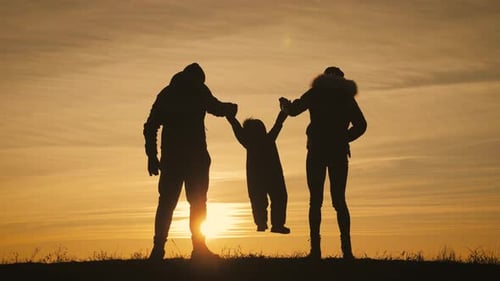 Silhouette Family Playing at Sunset