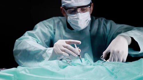 Surgeon Preparing Injection Before Operation in Dark Room