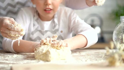 Girl and Adult Baking in Kitchen