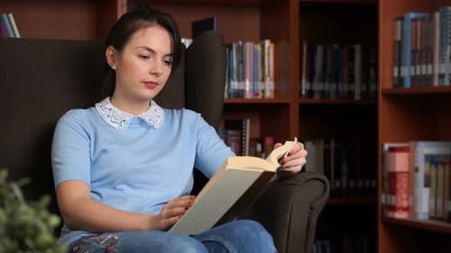 Portrait of Smiling Beautiful Pretty Woman with Book in Library Office Bookshelf Background